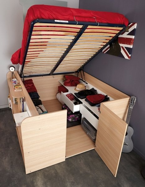 Кровать с большим количеством шкафчиков для хранения вещей.